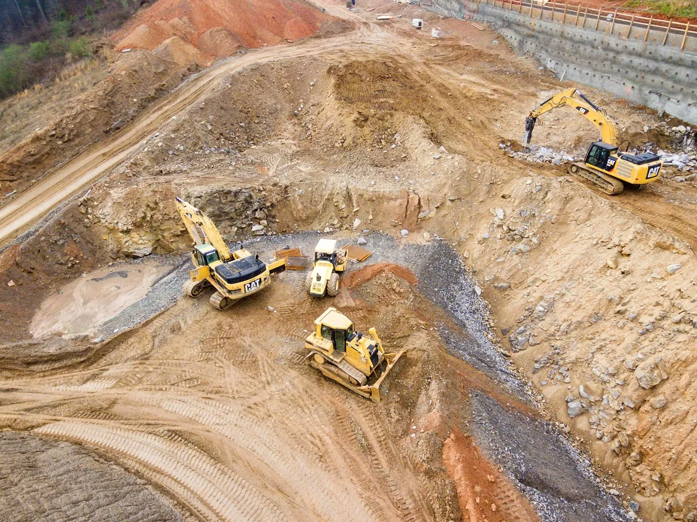 Aerial view of excavators and dozers working a quarry face